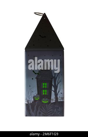 Halloween tin isolated on white background - all butter biscuit light up lantern with a creepy green LED tea light from M&S Stock Photo