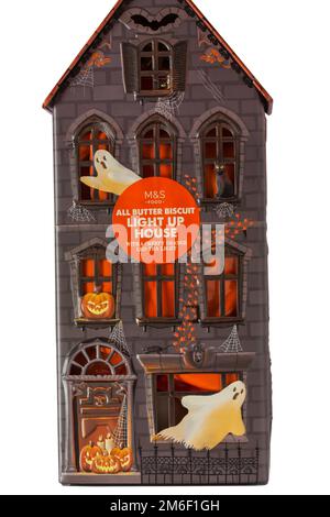 Halloween tin set on white background - all butter biscuit light up house with a creepy orange LED tea light from M&S Stock Photo