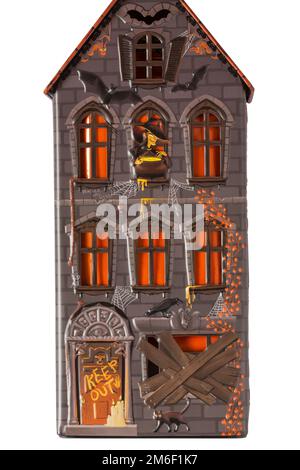 Halloween tin set on white background - all butter biscuit light up house with a creepy orange LED tea light from M&S Stock Photo
