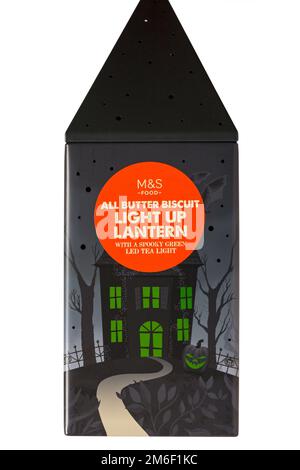 Halloween tin set on white background - all butter biscuit light up lantern with a creepy green LED tea light from M&S Stock Photo