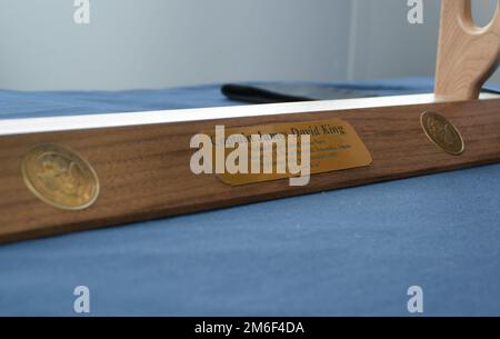 Cmdr. King's father's sword stands with an inscription reading his name lying on a table at Cmdr. King's commissioning ceremony. Dr. Richard King was commissioned as Cmdr. Richard King in a commissioning ceremony in Lewiston, Maine. Stock Photo