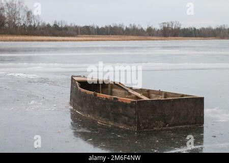 An old wooden boat on the river in autumn. Stock Photo