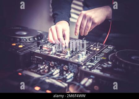 DJ at the remote control. Mixer remote at concert. Musical equipment. Stock Photo
