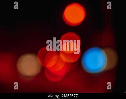 Beautiful bokeh colorful background.Long exposure light painting,orange vibrant neon.Blue,red,orange bokeh. designed background. Modern background. Stock Photo