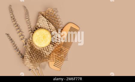 Sustainable solid shampoo bar and wooden comb laying on a Honeycomb Paper, pastel background. Eco friendly hair care. Plastic free, zero waste living, Stock Photo