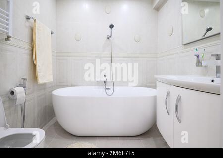 Compact white cozy bathroom with bathub Stock Photo