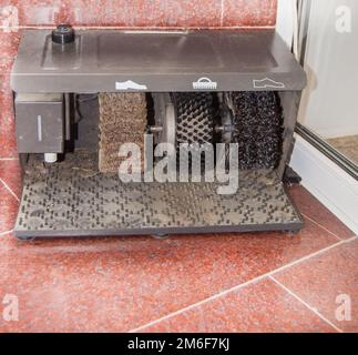 Electric Shoe cleaning machine for various types of shoes, LOCATED at the ENTRANCE to a LUXURY MODERN HOTEL ON the MARBLE FLOOR Stock Photo