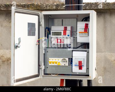 Introductory machine and electric energy meter in a dashboard on a pole on a land plot Stock Photo