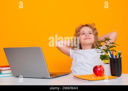 School child using laptop computer. School kid student learning, study language or literature at school. Elementary school child. Portrait of nerd Stock Photo