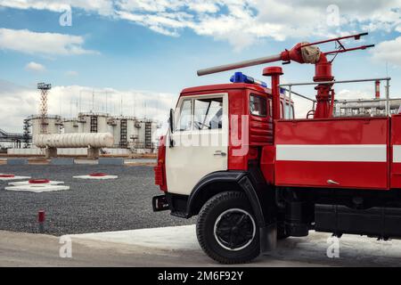 A fire truck is on duty at an oil refinery Stock Photo