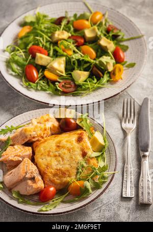 Salmon baked with cheese, served with vegetables. Stock Photo