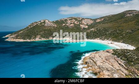 Beautiful image of turquoise colour water, little beach, and mountain range in Two Peoples Bay, Albany, Western Australia Stock Photo