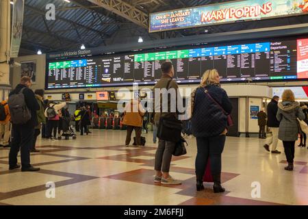 London- December 2022: Passengers at Victoria Station concourse Stock Photo