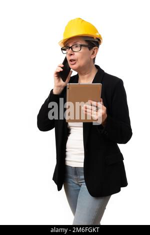 An engineer woman talking on the phone holding a tablet on white background Stock Photo