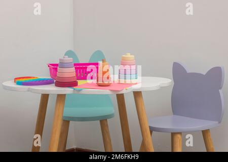 Children's work table in a pediatric office, with crayons for drawing and recreational toys. Stock Photo