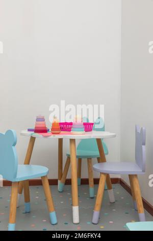 vertical image of a children's work table, with toys and things to draw. Stock Photo