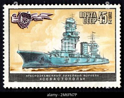 USSR - CIRCA 1982: USSR postage stamp dedicated to battleship Sevastopol. Stamp with image of Soviet Stock Photo