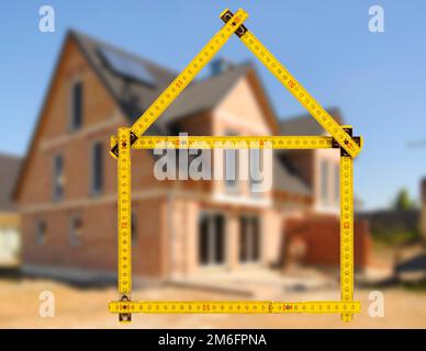 House construction in shell with meter stick as symbol Stock Photo