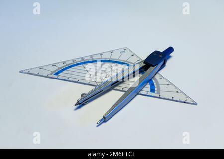 Geo triangle and drawing compass as used by schoolchildren in mathematics class Stock Photo
