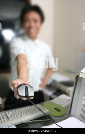 man giving the computer mouse blur face at bacground Stock Photo