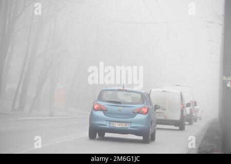 Visible air pollution at the streets of Belgrade, hazy foggy and polluted air and strong emission of CO2 Stock Photo