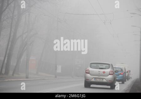 Visible air pollution at the streets of Belgrade, hazy foggy and polluted air and strong emission of CO2 Stock Photo