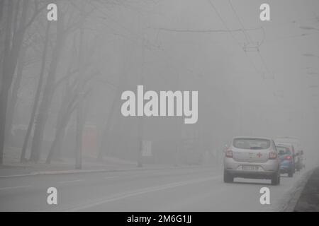 Visible air pollution at the streets of Belgrade, hazy foggy and polluted air and strong emission of CO2 Stock Photo