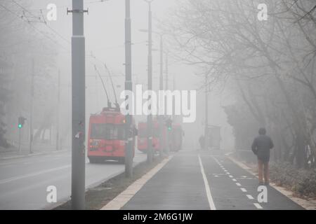 Visible air pollution at the streets of Belgrade, hazy foggy and polluted air and strong emission of CO2 Stock Photo