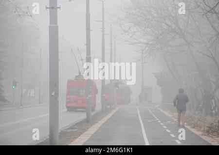 Visible air pollution at the streets of Belgrade, hazy foggy and polluted air and strong emission of CO2 Stock Photo