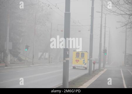 Visible air pollution at the streets of Belgrade, hazy foggy and polluted air and strong emission of CO2 Stock Photo