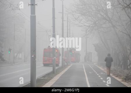 Visible air pollution at the streets of Belgrade, hazy foggy and polluted air and strong emission of CO2 Stock Photo