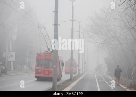 Visible air pollution at the streets of Belgrade, hazy foggy and polluted air and strong emission of CO2 Stock Photo