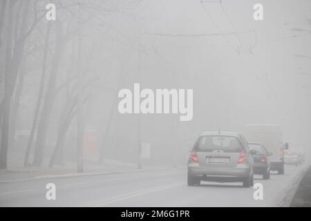 Visible air pollution at the streets of Belgrade, hazy foggy and polluted air and strong emission of CO2 Stock Photo