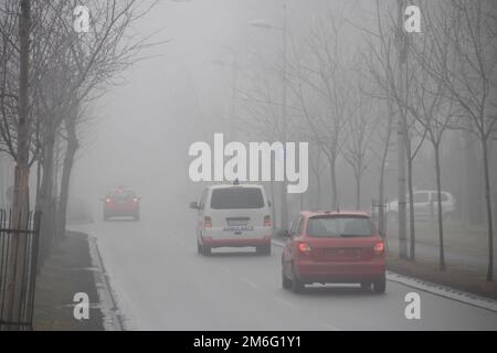 Visible air pollution at the streets of Belgrade, hazy foggy and polluted air and strong emission of CO2 Stock Photo