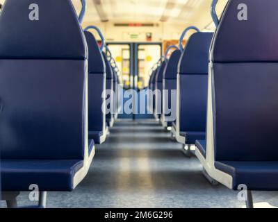 An empty train car with blue leather seats Stock Photo