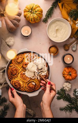 Cinnamon pumpkin dough bun rolls spicy homemade traditional Danish baked vegan sweet fall treat cake holiday dessert swirl bread pastry food with raw Stock Photo