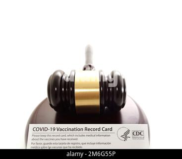 Legal gavel and US COVID-19 Vaccination Record card Stock Photo