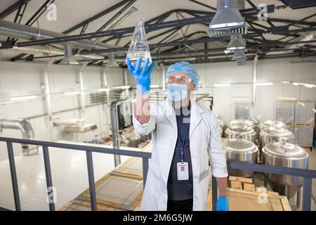 Brewer performing the quality check of a beverage sample Stock Photo
