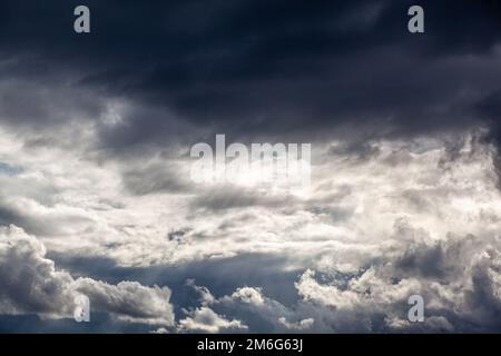 Dramatic sky with grey clouds over the city before the storm. Stock Photo