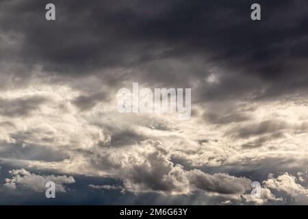 Dramatic sky with grey clouds over the city before the storm. Stock Photo