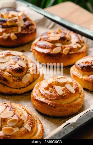 Fresh Homemade Rolls Buns with apples and cinnamon in glaze on a table with natural linen tablecloth. Top view flat lay background. Stock Photo