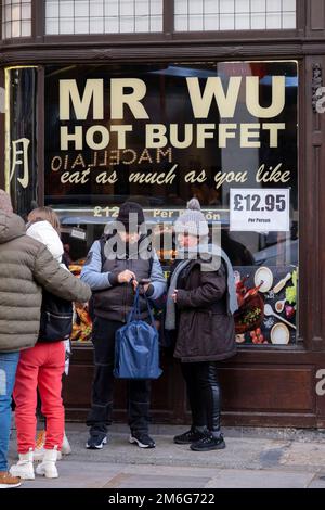 Mr Wu Eat as much as you like Chinese hot buffet style restaurant in Chinatown on 6th December 2022 in London, United Kingdom. Many people eat bargain food responsibly and it provides great value for consumers, however concerns over obesity levels in the UK remain, especially with foods containing high levels of fat and sugar. Obesity is a medical condition in which excess body fat has accumulated to the extent that it may have a negative effect on health. Stock Photo