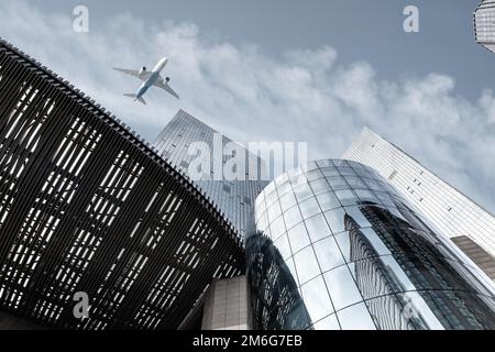 Modern building with airplane against a blue sky Stock Photo