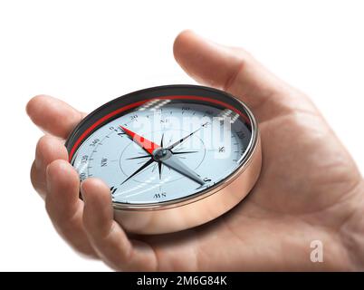 Hand holding a compass over white background. Strategic orientation or direction concept. Stock Photo