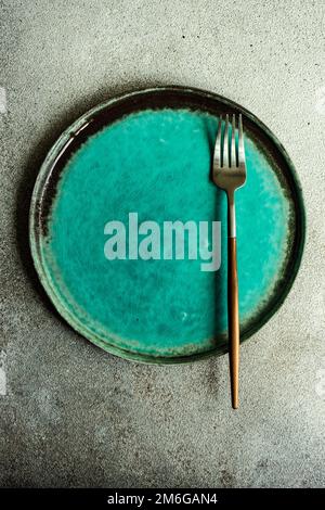 Minimalistic table setting with plate and cutlery Stock Photo
