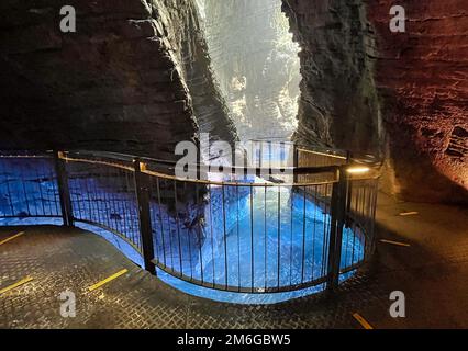 Colorfull waterfall in a cave cascate del varone at riva del garda Stock Photo