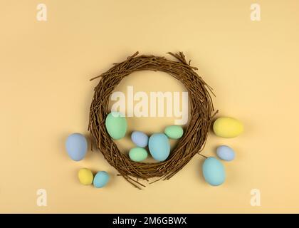 Multicolored pastel decorative Easter eggs and willow wreath. Happy Easter card Stock Photo