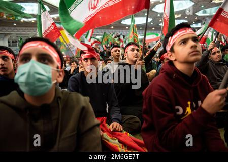 Tehran, Iran. 03rd Jan, 2023. Mourners wave Iranian and Islamic flags during a ceremony marking anniversary of the death of the late Revolutionary Guard Gen. Qassem Soleimani, who was killed in Iraq in a U.S. drone attack in 2020, at Imam Khomeini Grand Mosque in Tehran, Iran, Tuesday, Jan. 3, 2023. (Photo by Sobhan Farajvan/Pacific Press/Sipa USA) Credit: Sipa USA/Alamy Live News Stock Photo