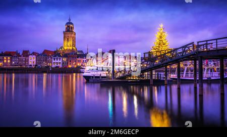 A ship near a harbor on the river IJssel in Deventer  with the St. Lebuinus Church on the background Stock Photo