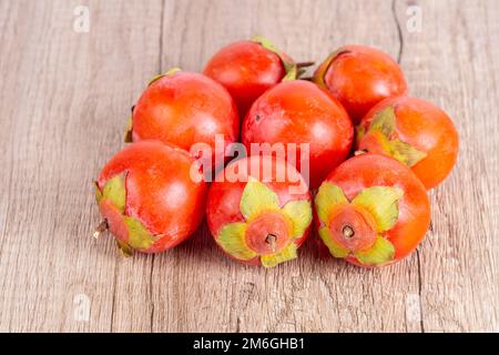 Persimmons fruit on wooden table Stock Photo